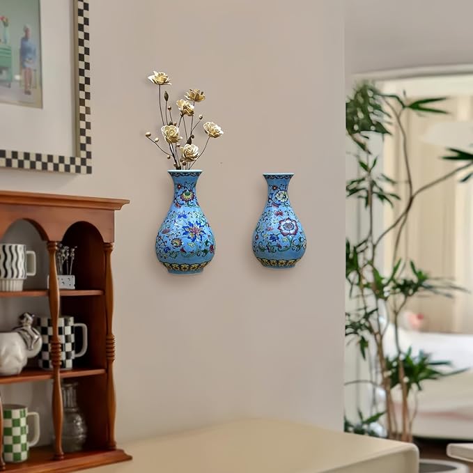 Set of two blue chinoiserie porcelain wall vases on a light wall