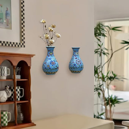 Set of two blue chinoiserie porcelain wall vases on a light wall