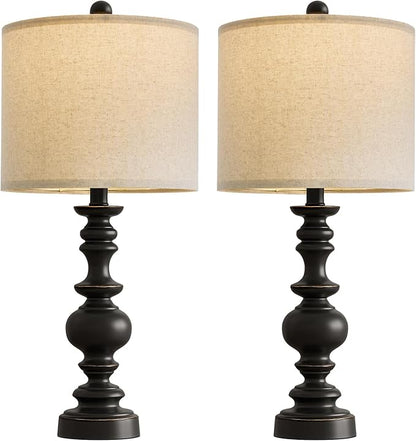 Pair of farmhouse table lamps with turned black resin bases and beige linen drum shades
