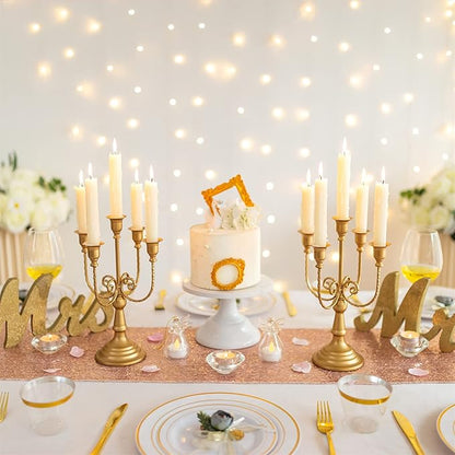 Gold 5-arm metal candelabra centerpiece with five lit taper candles on a table