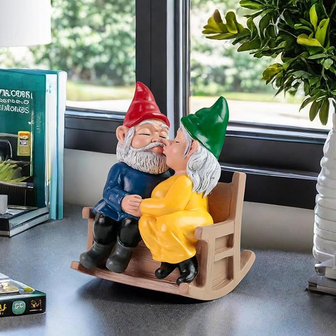 Garden gnome couple rocking chair statue on patio, kissing, red and green hats, blue and yellow