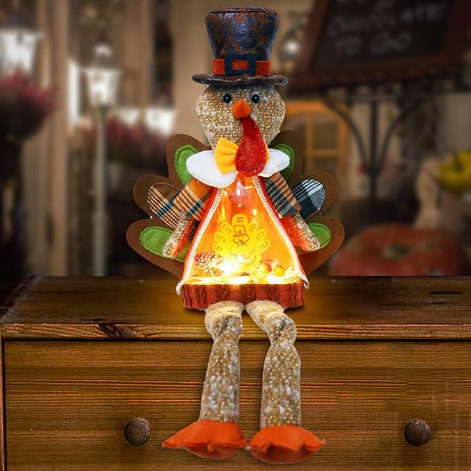 Light-up plush turkey doll with top hat and bow, glowing orange chest, brown legs, orange feet