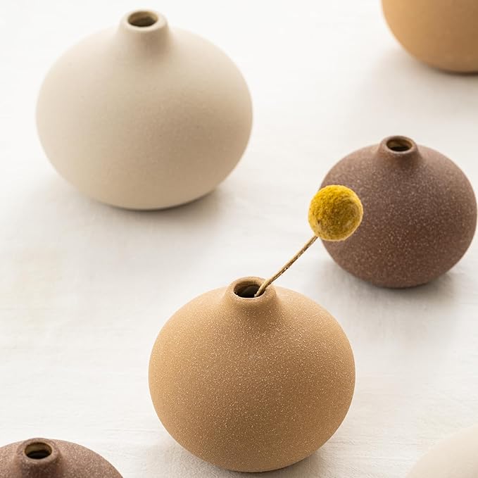 Three mini matte ceramic bud vases with textured finish, short neck openings visible