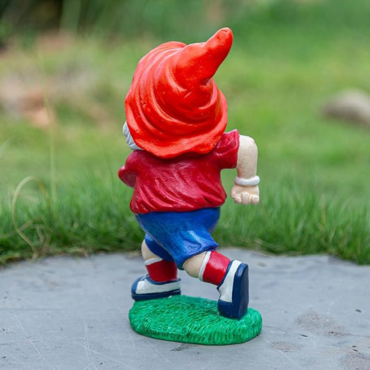 Rugby-themed garden gnome statue side view, red hood, blue shorts, holding a football