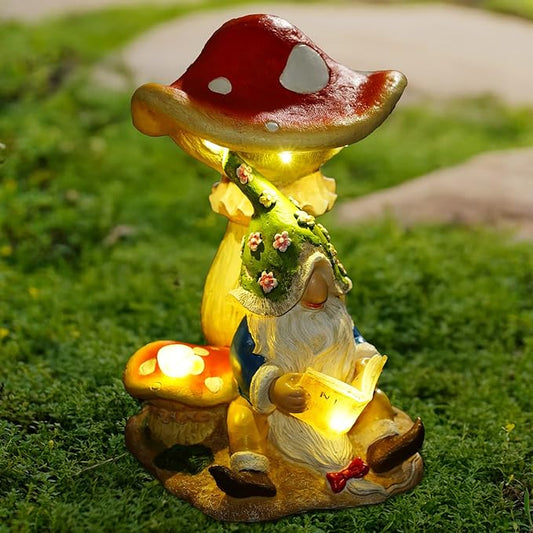 Solar gnome figurine reading under red mushroom with warm LED lights on a base