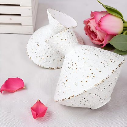 White hammered cast iron vase with angled neck, speckled finish, with flower blooms nearby