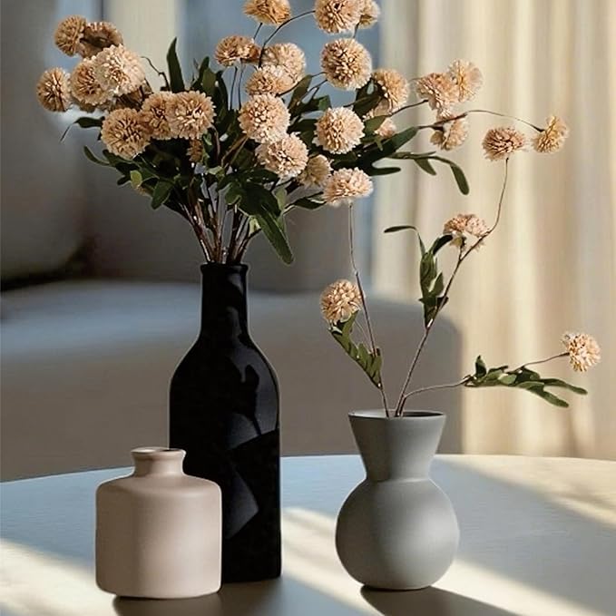 Ceramic vase arrangement with black, cream, and light gray vases and faux chrysanthemum heads