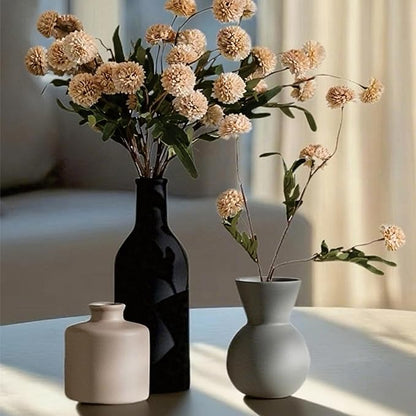 Ceramic vase arrangement with black, cream, and light gray vases and faux chrysanthemum heads