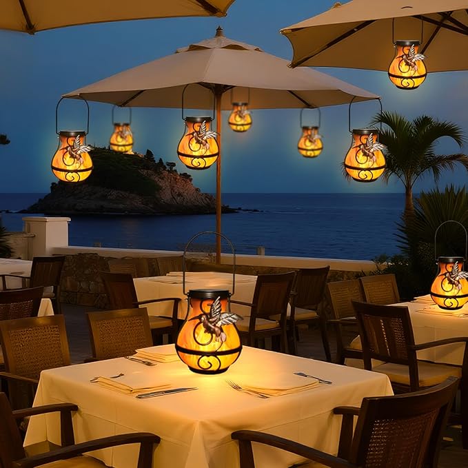 Solar hanging lanterns, multiple orange flame lights hanging above outdoor dining