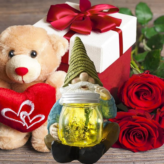 Solar gnome jar lantern figurine on a table with teddy and roses beside