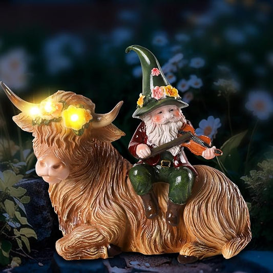 Solar resin highland cow figurine with gnome playing violin, warm glowing light