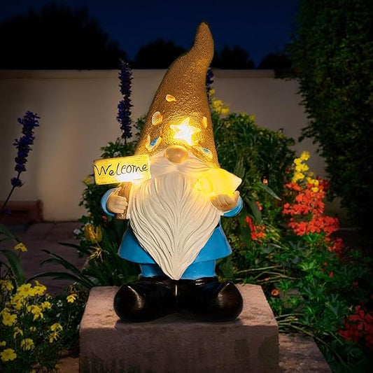 Outdoor solar gnome statue with glowing hat, white beard, blue outfit, black boots, Welcome sign