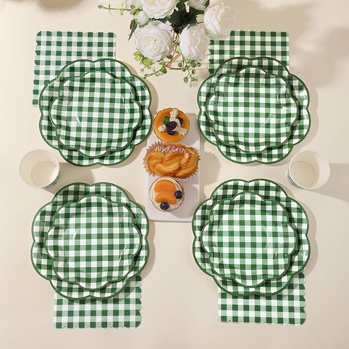 Green-and-white gingham picnic tableware set with round plates and folded napkins for gatherings