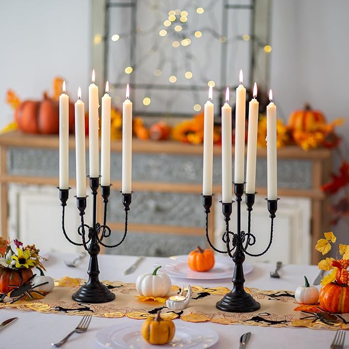 Black metal five-stem taper candelabra candle holders on wedding table centerpiece