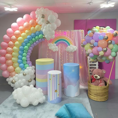 Large rainbow balloon arch with pink, orange, blue, green, and white balloon clusters