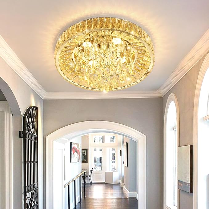 Gold-tone crystal flush mount chandelier with bright glow in hallway ceiling