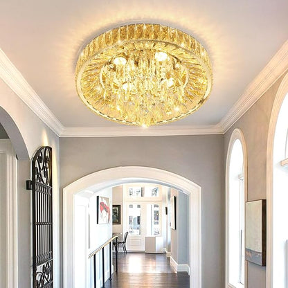 Gold-tone crystal flush mount chandelier with bright glow in hallway ceiling