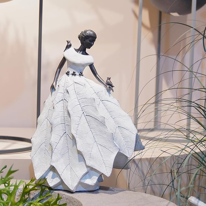White resin fairy maiden statue in side view with layered dress and raised bird hand