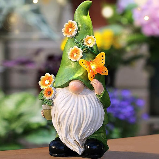 Green resin garden gnome statue with white beard, orange flowers, and butterfly on hat