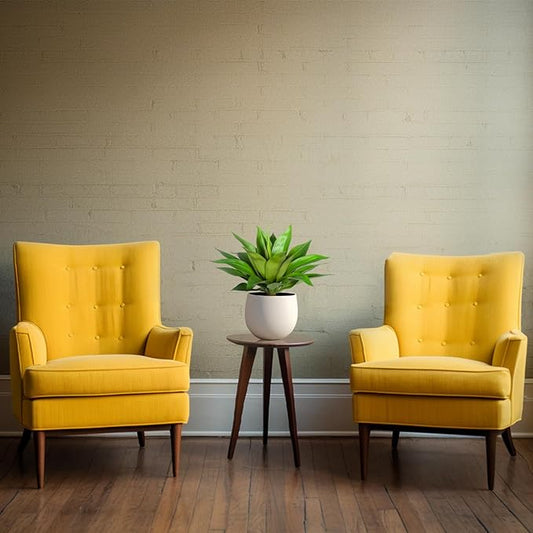 Green faux agave plant in a white pot on a small side table