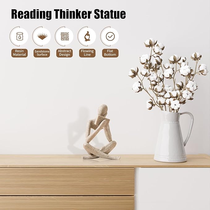 Beige seated reading thinker resin statue on tabletop, abstract sculpted reading pose