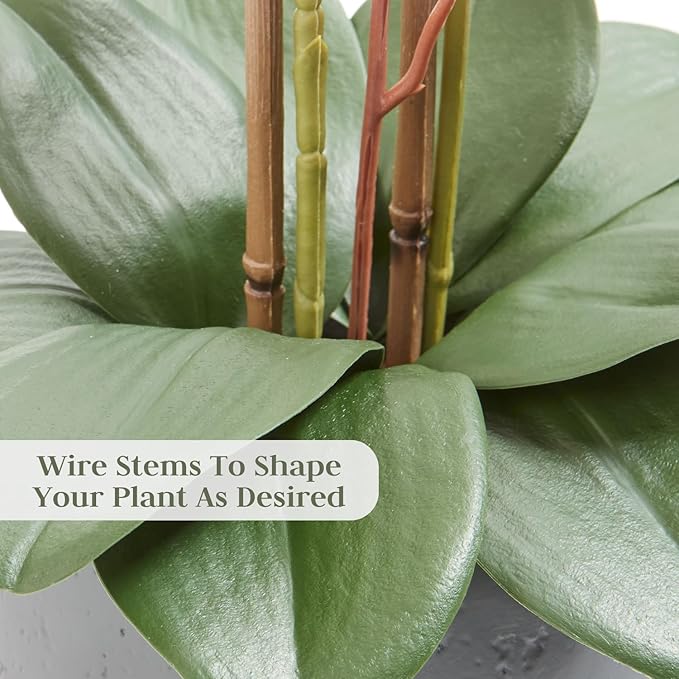 Wire-stem faux orchid with green leaves and gray pot, close-up