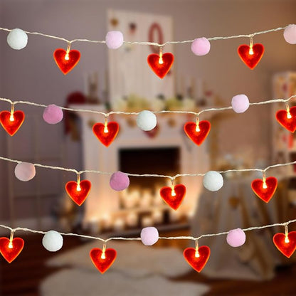 Valentine string lights garland with red heart LEDs and pink pom poms, warm glow
