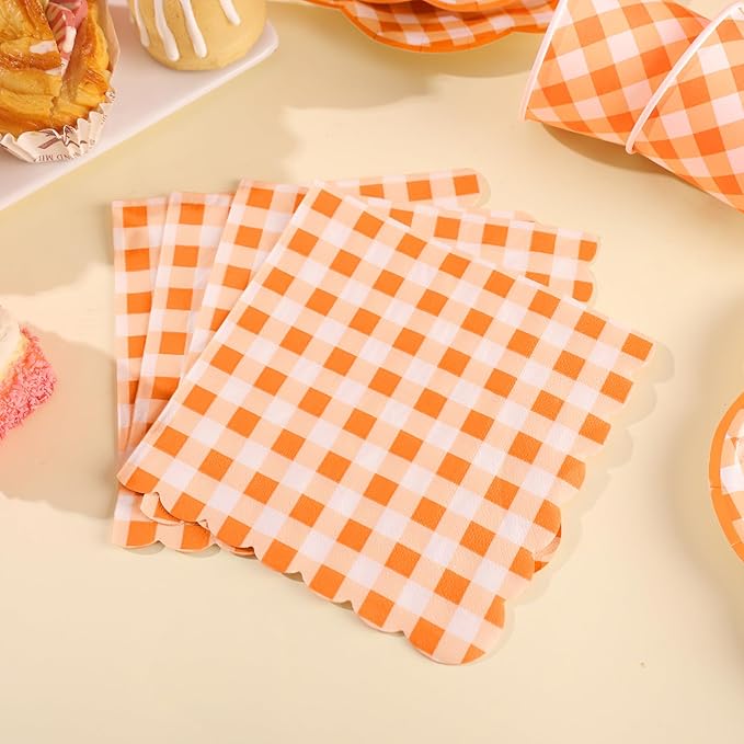 Orange and white gingham paper napkins folded in a stack