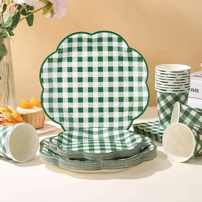 Green-and-white gingham picnic tableware set with stacked plates and cups on a table
