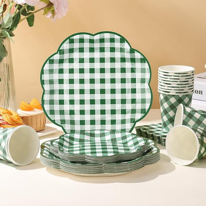 Green-and-white gingham picnic tableware set with stacked plates and cups on a table
