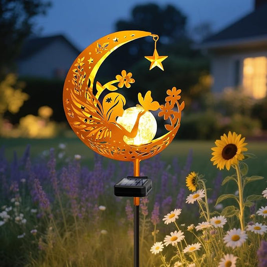 Orange crescent solar garden light with angel glass globe on ground stake, warm glow.