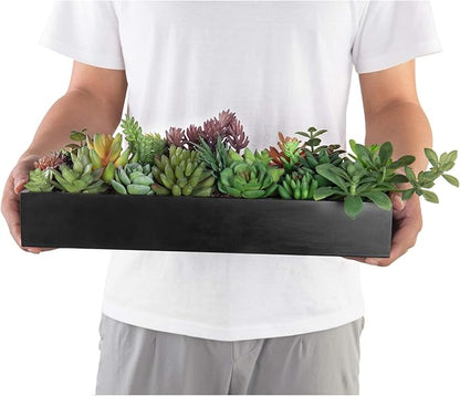 Black wood planter faux succulent centerpiece held in hands with green and purple leaves