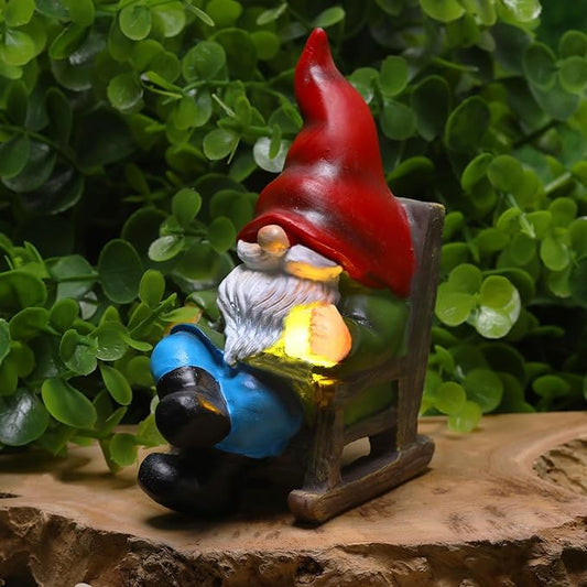 Miniature garden gnome solar light figurine with red hat, blue outfit, glowing lantern in hand