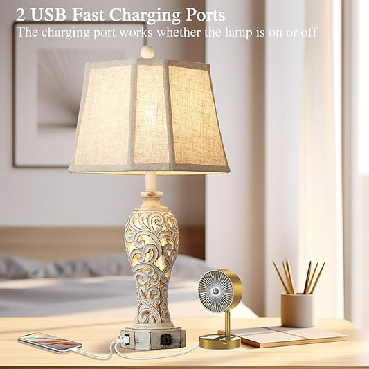 Table lamp with beige fabric shade and ornate white resin base with dual USB ports