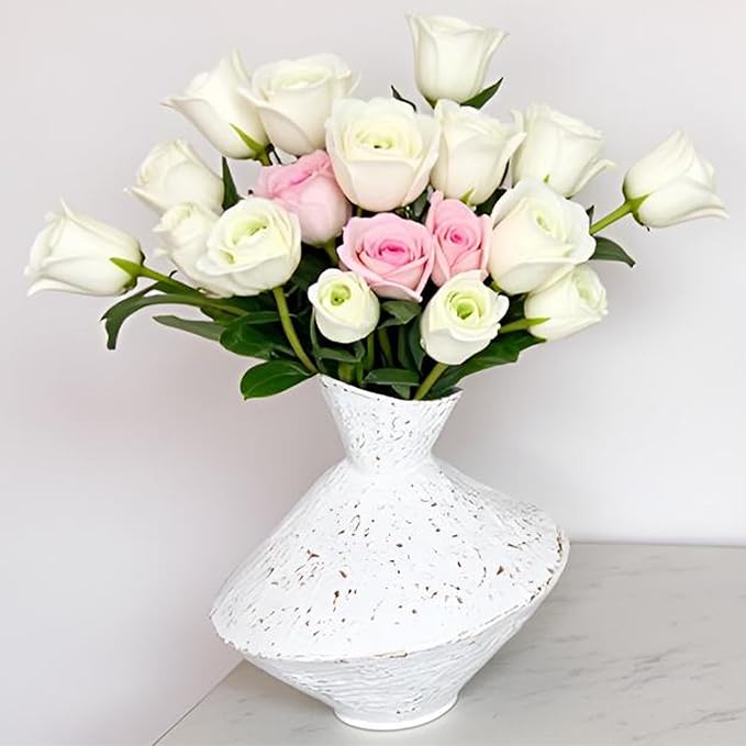 White hammered cast iron vase with angled neck, speckled texture, filled with roses