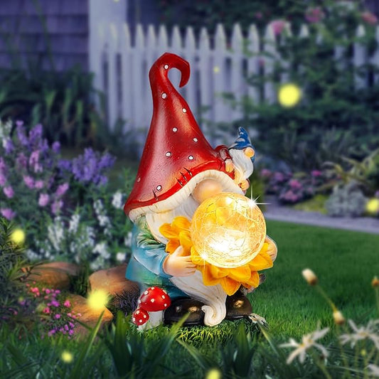 Solar garden gnome statue with red hat holding a glowing yellow sunflower and mushroom