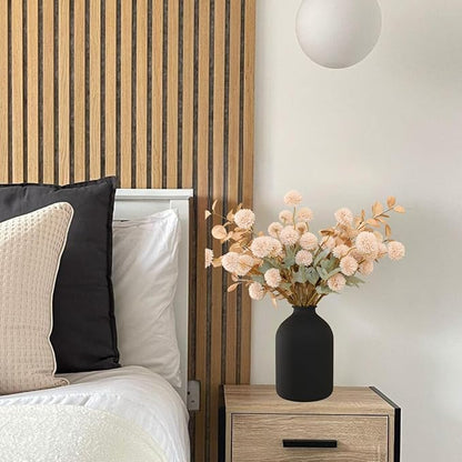 Beige faux chrysanthemum pom-pom stems with gold eucalyptus accents in a vase