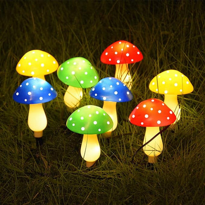 Outdoor cluster of solar mushroom LED lights with multi-color dotted caps on grass