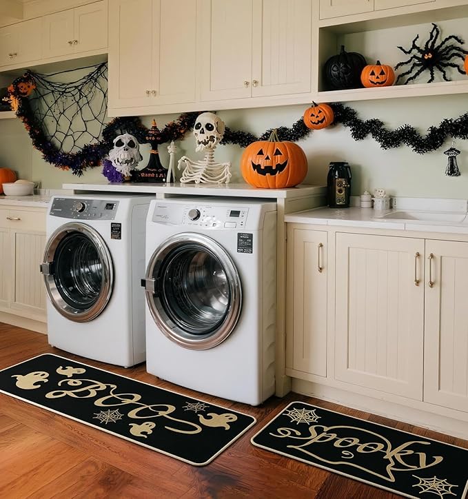 Set of 2 black kitchen rugs with gold ghosts and spider web motifs in a laundry room