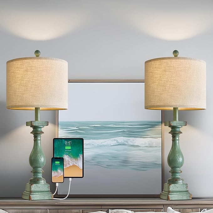 Pair of green table lamps with beige drum shades on console table