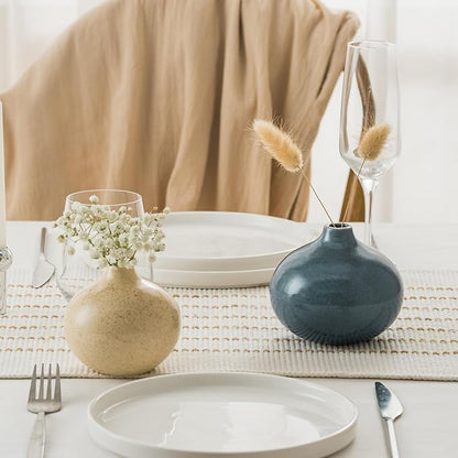 Set of 3 mini ceramic bud vases on table: cream and gold with blue vase.