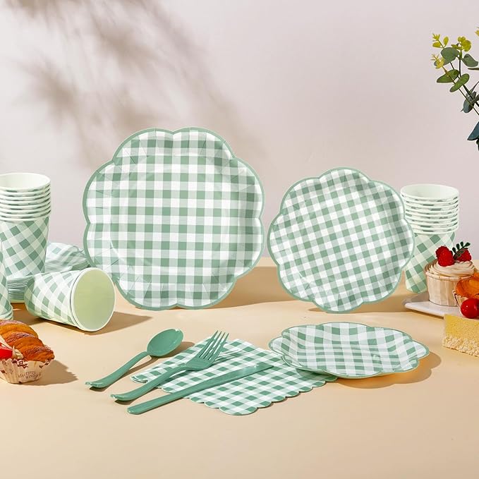 Sage green gingham dinnerware pieces: plates, cups, forks, and knives on tabletop