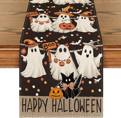 Halloween table runner with black fabric, ghosts, pumpkins, cat, and “Happy Halloween” text