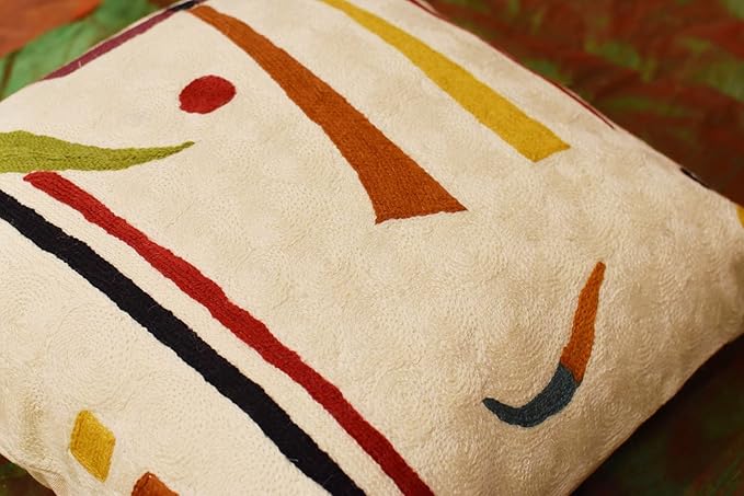 Cream pillow cover close-up with orange, yellow, red, and black diagonal stripes
