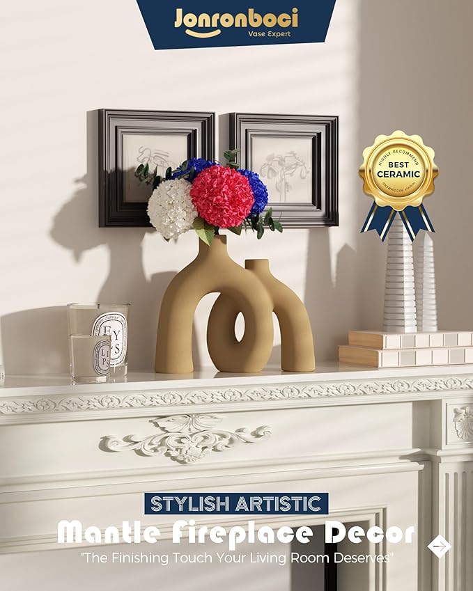 Matte tan-brown ceramic hug vase with conjoined donut shape, styled on mantel.