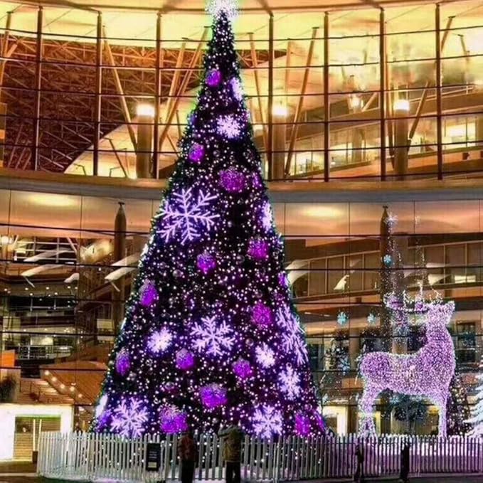 Purple LED mini string lights on a tall Christmas tree in an indoor atrium