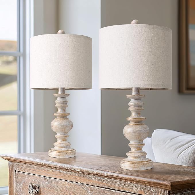 Pair of farmhouse table lamps with tall whitewashed resin bases and beige linen shades