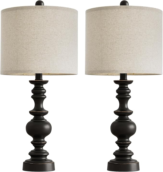 Pair of farmhouse table lamps with black resin column bases and beige linen drum shades