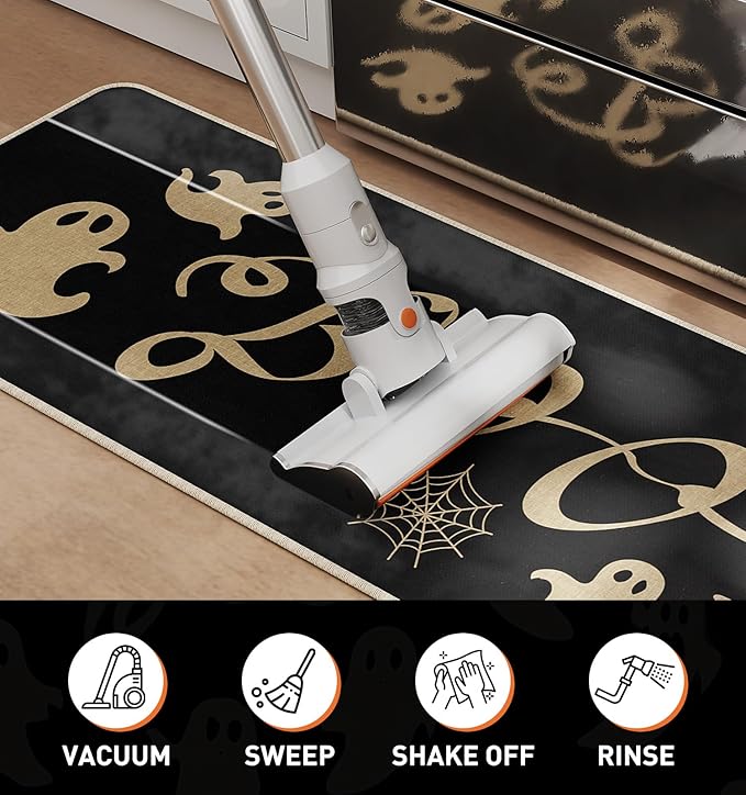 Black Halloween kitchen rug with gold ghost and spider web pattern, vacuumed