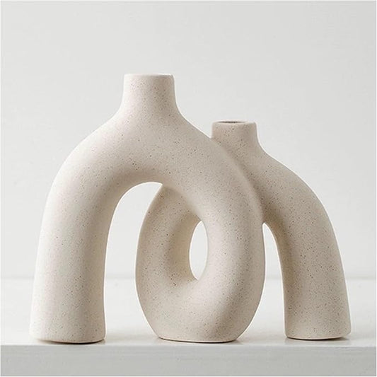 Matte cream ceramic conjoined hug vase with two circular openings, rounded short form